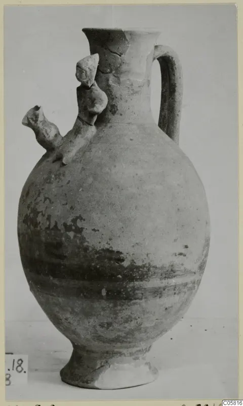 Pottery Black-on-Red jug from Marion, with a tubular spout, strap handle and ring foot