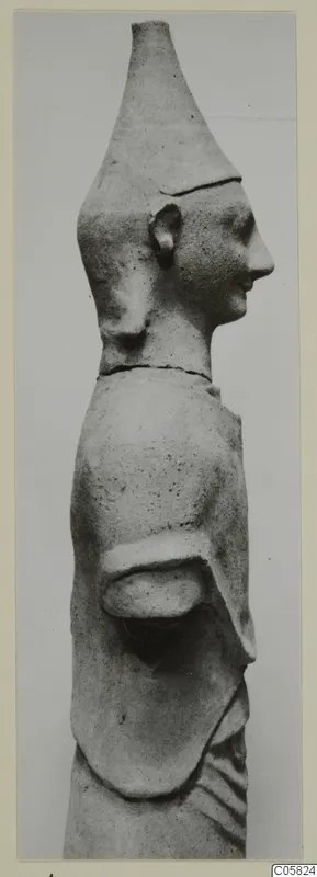 Terracotta statuette of a figure in side profile facing right, with a tall conical headdress and one arm bent at the waist