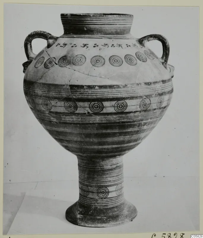 White Painted V pottery stand-vessel with two handles, concentric circle and swastika-like painted motifs.