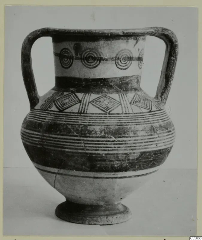 Two-handled painted pottery vessel on a low foot, with a band of concentric circles and diamond motifs