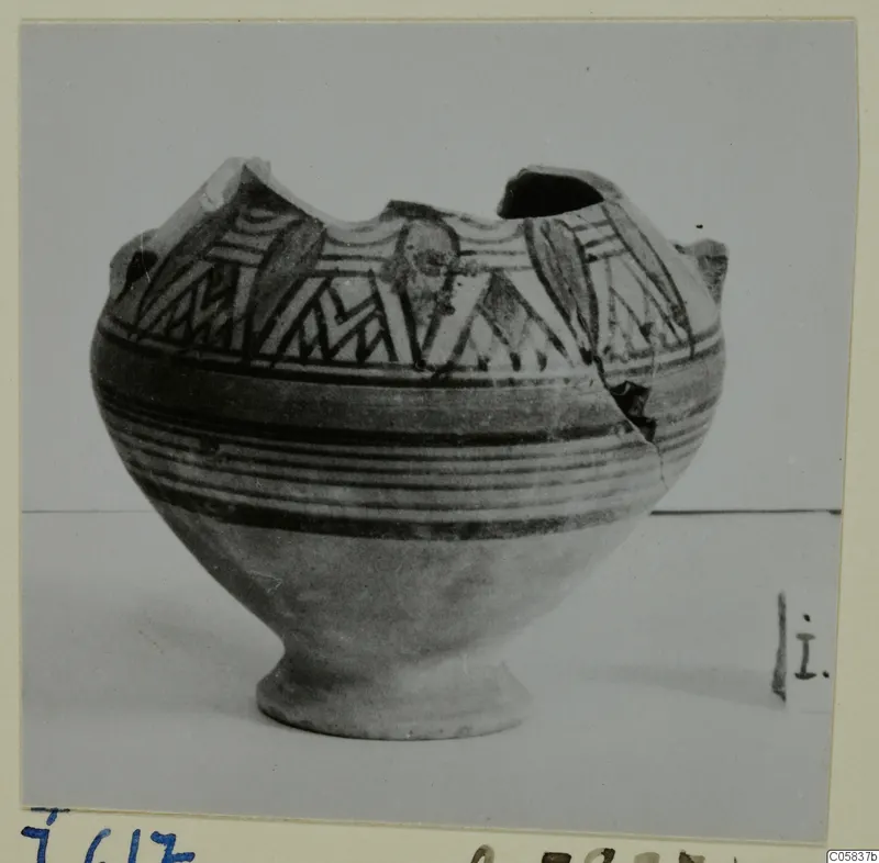 Pottery Bichrome IV amphora-crater with a broken rim, decorated with dark bands and angular patterns on a pale body.