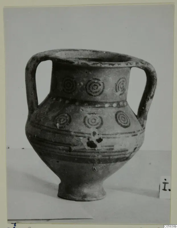Pottery Bichrome V two-handled jar with dark concentric circle motifs and horizontal painted bands