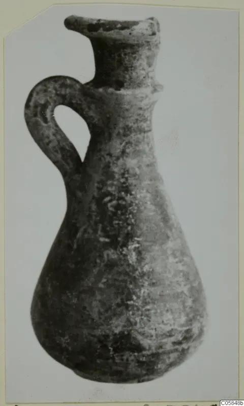 Grey Polished Ware jug with a single loop handle and flared rim, from Idalion