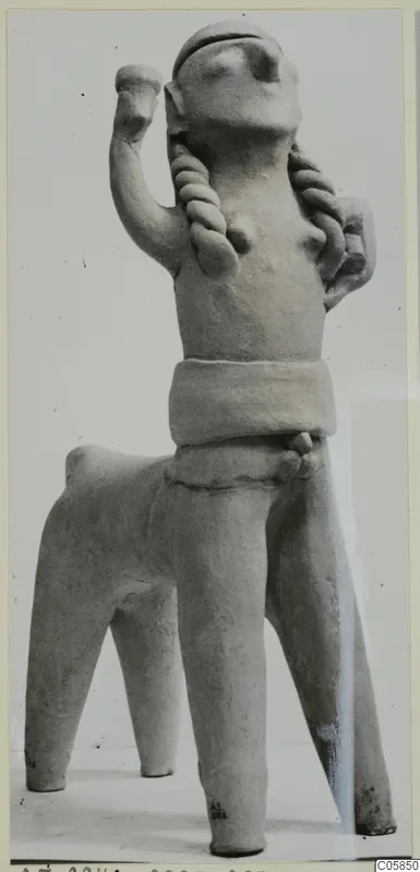 Terracotta figurine from Ayia Irini with a human-like upper body, one raised arm and braided hair, joined to a four-legged body.