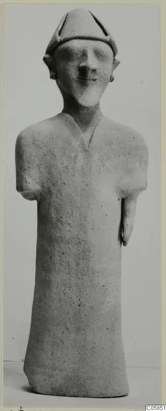 Standing terracotta figurine with a pointed cap and stub arms, from Ayia Irini