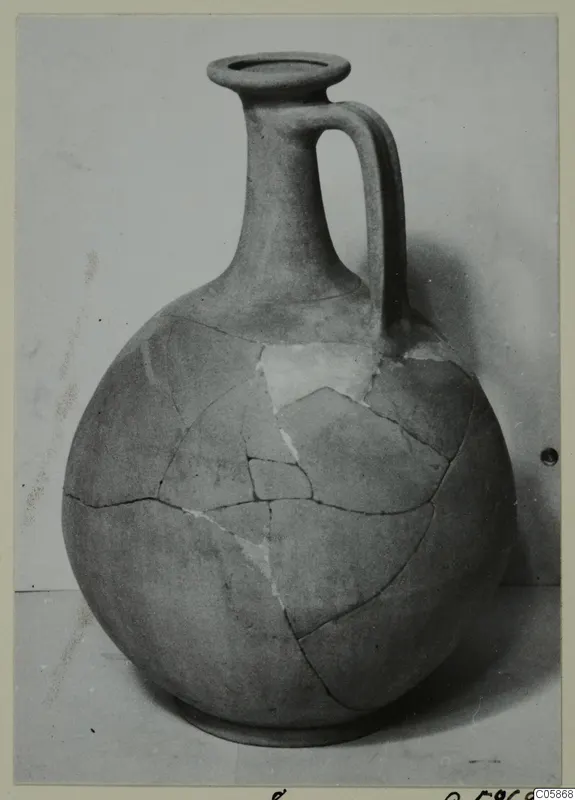 Round-bodied jug with a tall neck and single loop handle, mended from sherds, from Idalion