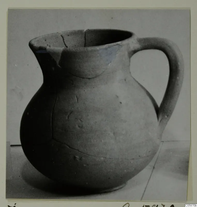 Cypro-Hell. II jug with a single loop handle and a rounded body, photographed on a plain surface.