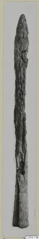 Long, narrow corroded iron blade with a pointed tip, shown upright.