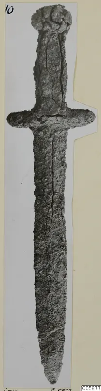 Iron sword with a rounded pommel, cross-guard and long tapering blade, its surface corroded.