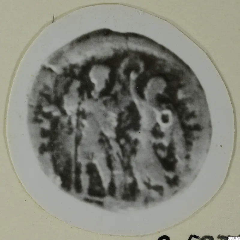 Blurred round object with worn raised markings, mounted on a white circular card in a cream frame