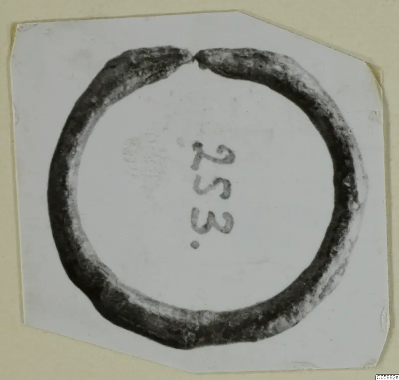 Bronze finger ring with a small gap, from Idalion, photographed on white card with a number label