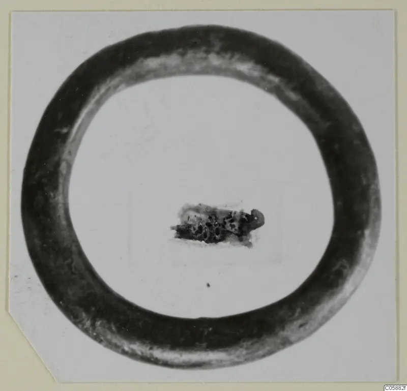 Bronze bracelet, a plain closed ring, lying flat on a pale background.