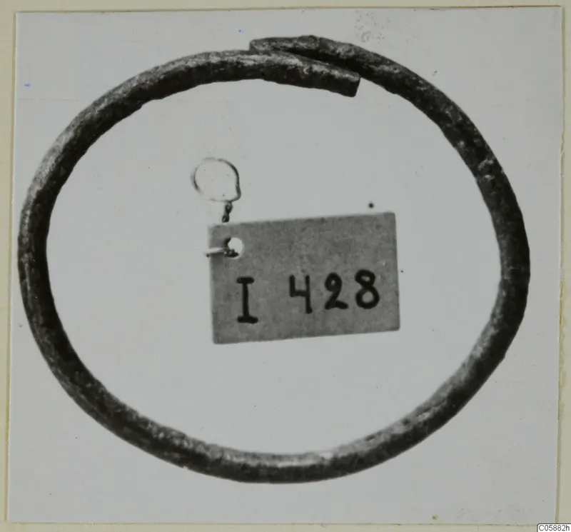 Bronze bracelet from Idalion, an open ring with overlapping ends, shown against a pale background