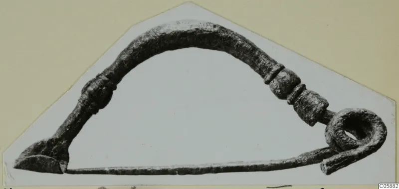 Bronze personal adornment from Idalion with an arched bow, moulded swellings and a coiled loop at one end