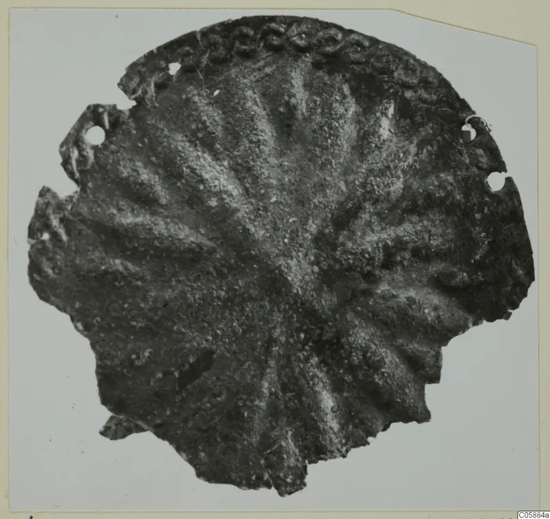 Fragment of a bronze mounting with radiating ribs and a beaded border, from Idalion