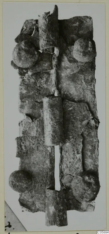 Corroded bronze mounting with tubular sections and round domed studs, from Idalion