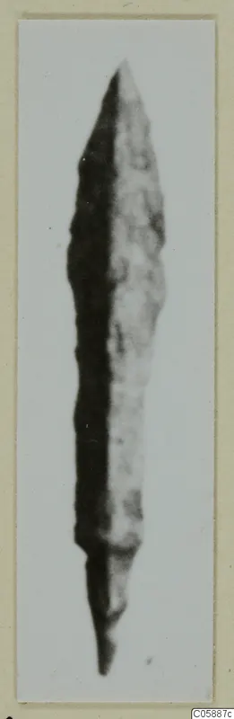Pointed, elongated metal blade, probably a weapon, from Idalion, shown on a mounted photograph card.