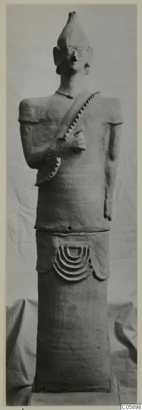 Terracotta Proto-Cypriote II, a standing figure with a conical headdress and a cylindrical base, from Ayia Irini