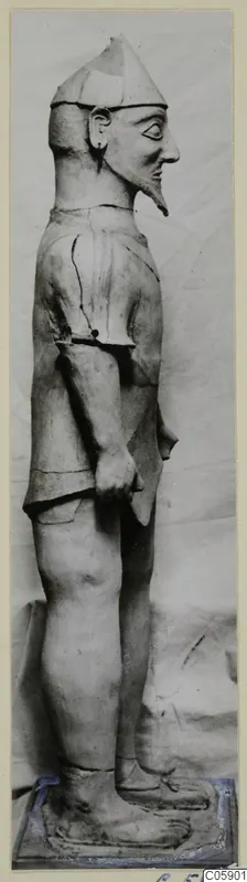 Terracotta Proto-Cypriote I, a standing bearded figure in profile facing right, on a base.