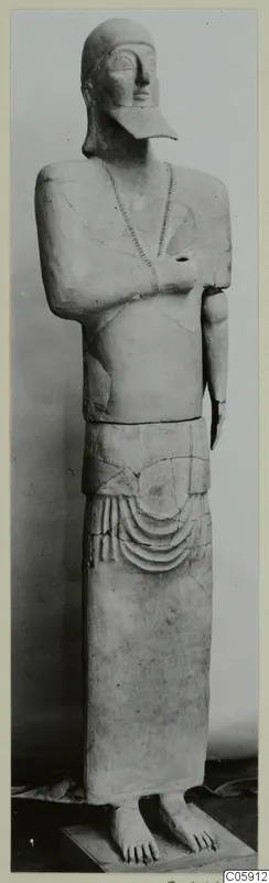 Terracotta Neo-Cypriote statue from Ayia Irini, standing with arms crossed over the chest