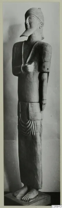Terracotta Neo-Cypriote statue of a standing figure with a long pointed nose and close-fitting cap