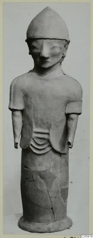 Terracotta Proto-Cypriote I: standing figure with a pointed cap and short sleeves, on a flat base