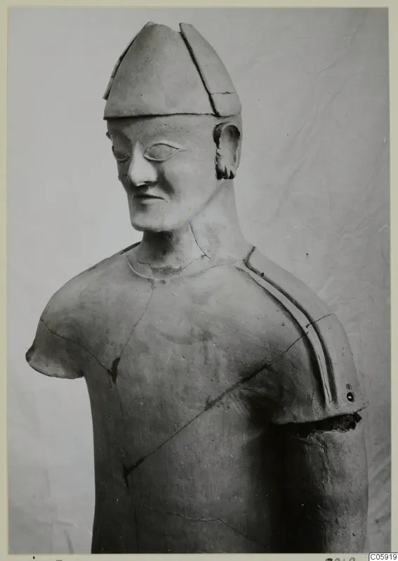 Terracotta statue, upper body of a figure in a tall cap, from Ayia Irini.