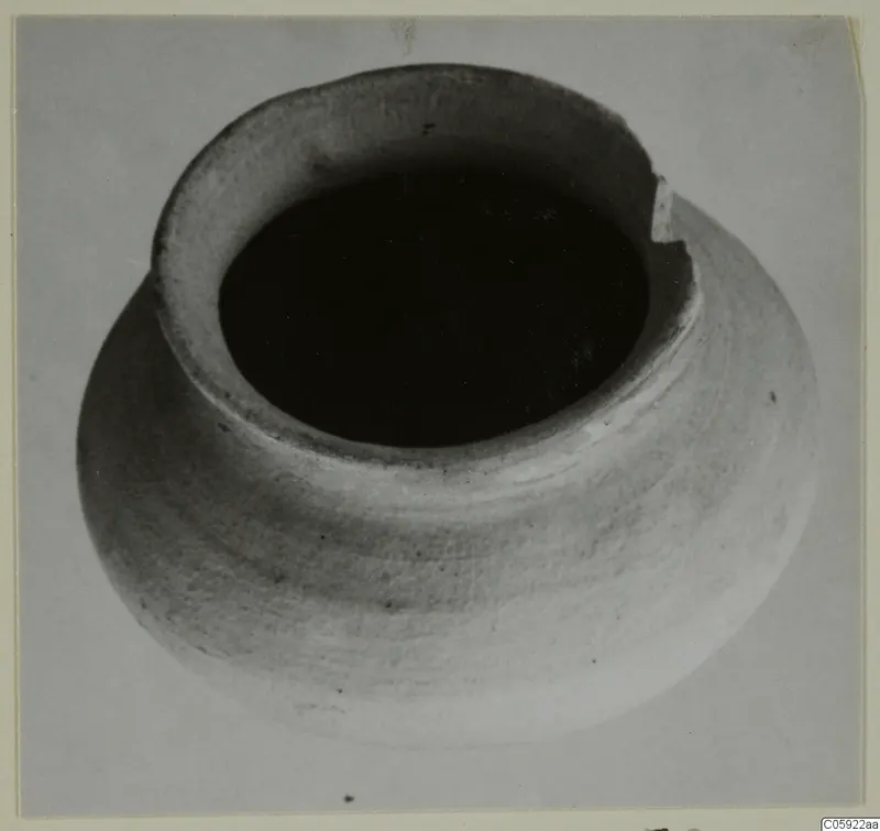 Plain white pottery vessel with a wide mouth and rounded body, seen from above.