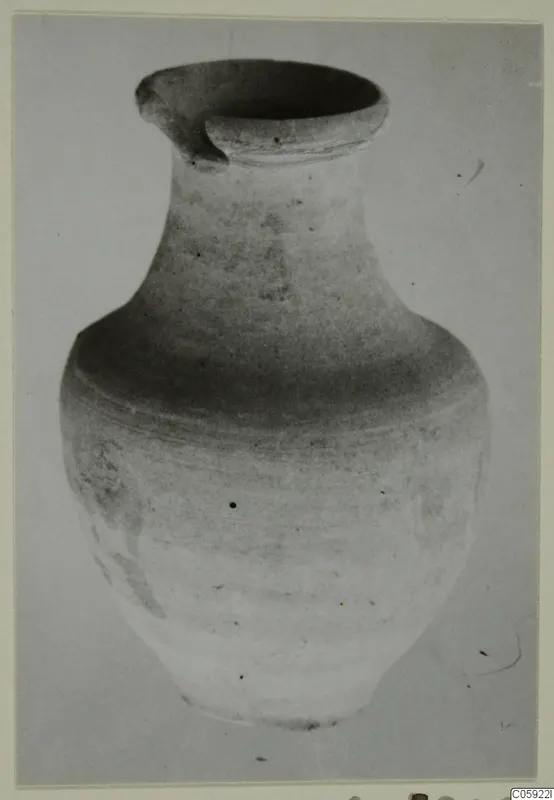 Pottery Plain White IV-V vessel with a wide mouth and pinched spout, photographed against a plain background.