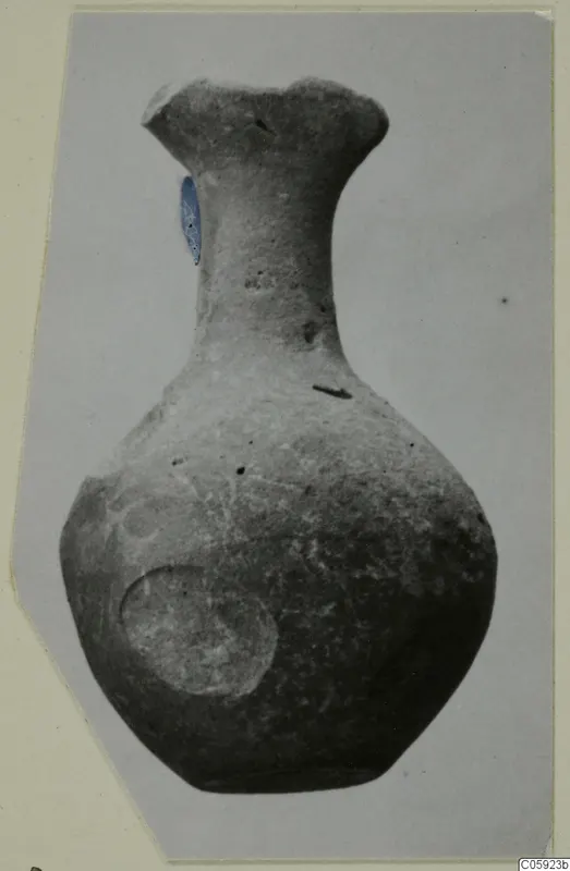 Grey polished pottery bottle with a flared rim and a round body, photographed against a plain background.