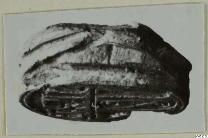 Stone scarab from Idalion, with a ridged domed back and incised lines on its flat base