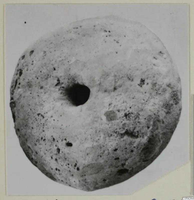 Large disc-shaped find with a central hole and pitted surface, from Idalion