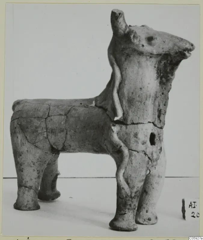 Terracotta figurine of a four-legged animal seen in profile, with a thin applied clay strip on its neck and body