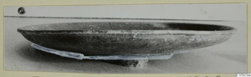 Shallow pottery plate from Amathus, tombs 1–9, photographed from the side.