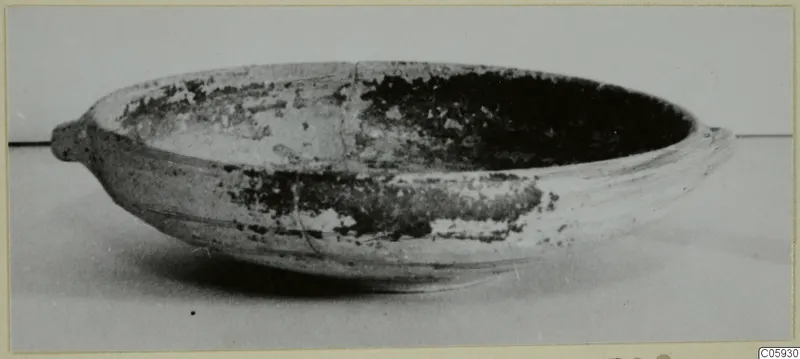 Shallow Black-on-Red pottery bowl with two small lugs, seen from the side