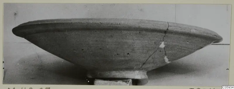 Pottery Plain White VII bowl in side profile, with a wide flaring rim and a cracked, repaired side
