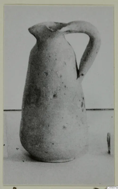 Pottery Plain White IV-V jug with a strap handle and pinched spout, shown on a light surface.