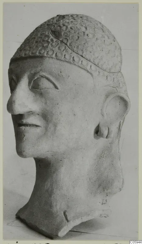 Terracotta head of a man from Ayia Irini, wearing a cap decorated with rows of circular impressions