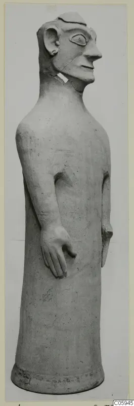 Terracotta statue of a tall standing figure with a long neck and head in profile, from Ayia Irini