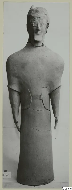 Terracotta statuette of a standing figure with a rounded head, short projecting arms and a tall cylindrical body