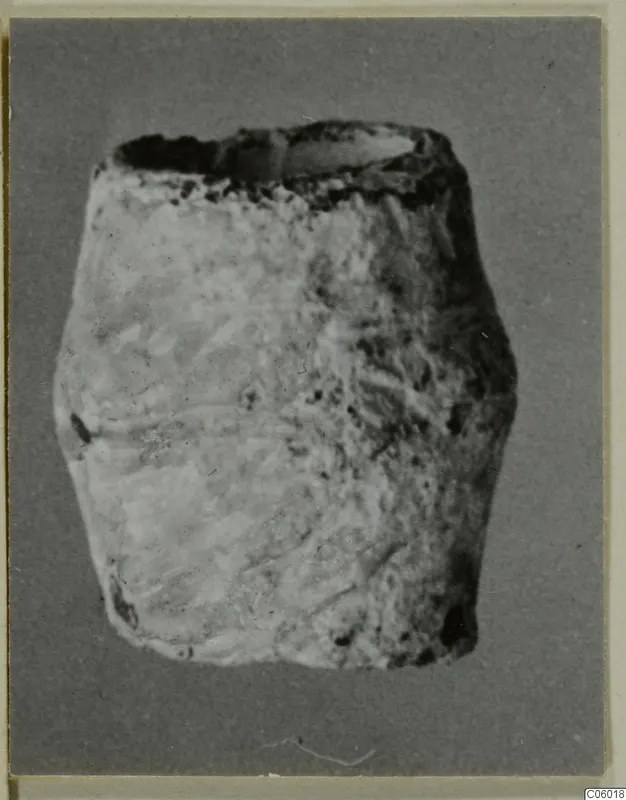 Squat lead container with an open top, photographed against a plain grey backdrop.