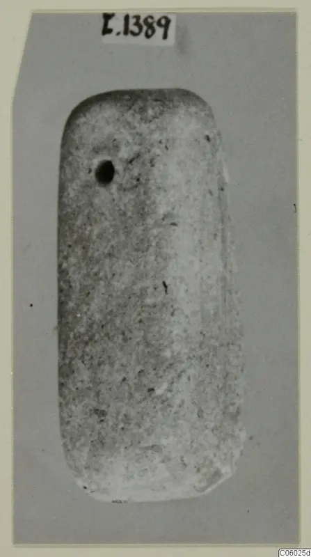 Rectangular stone object with rounded corners and a small hole near its upper left