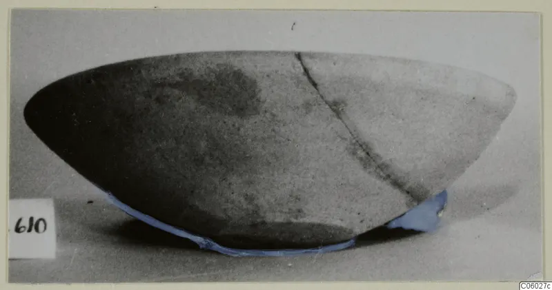 Plain White bowl from Idalion, photographed from the side, with a long crack running down the wall