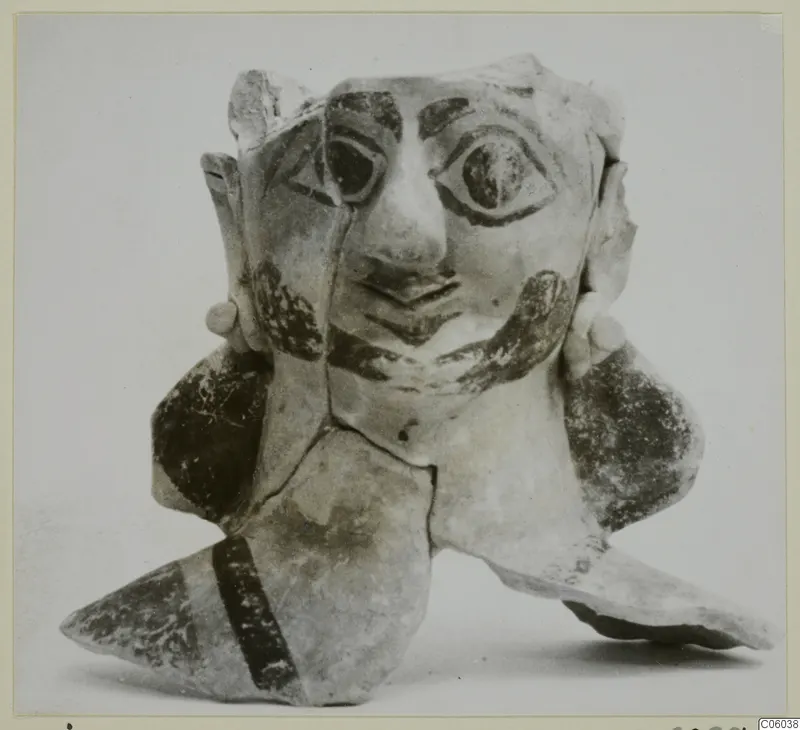 Terracotta figure with a painted face and broken body pieces, from Ayia Irini