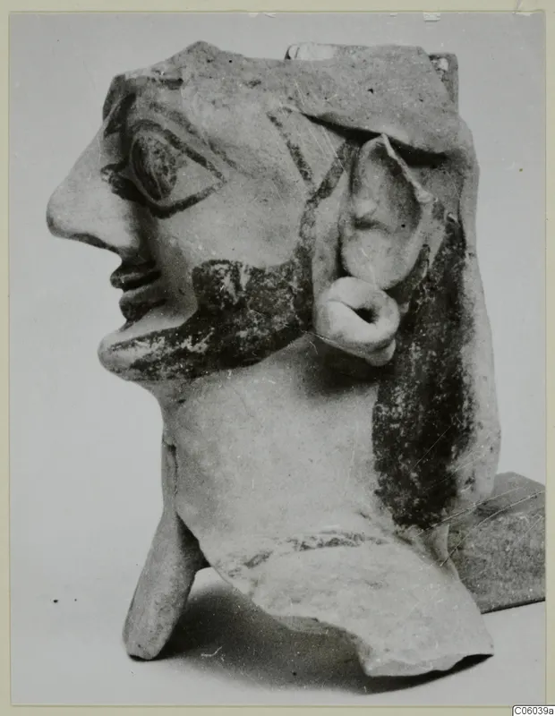 Terracotta head with painted beard and hair, shown in profile, from Ayia Irini