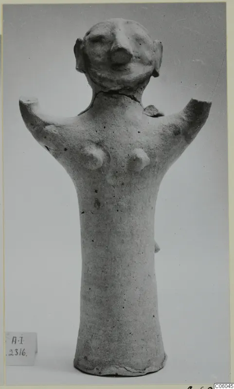 Terracotta figurine with short broken arm stubs, a rounded head with a large nose and ear-like projections