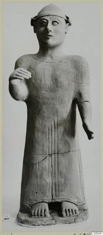 Terracotta standing figure in a long garment with one hand raised, from Ayia Irini