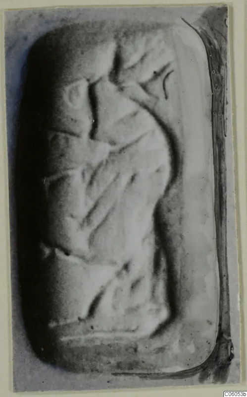 Engraved stone seal with rounded corners, photographed close up on a grey background