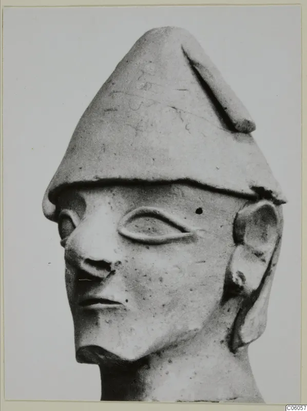 Terracotta head with a tall conical cap, large almond-shaped eye and prominent nose