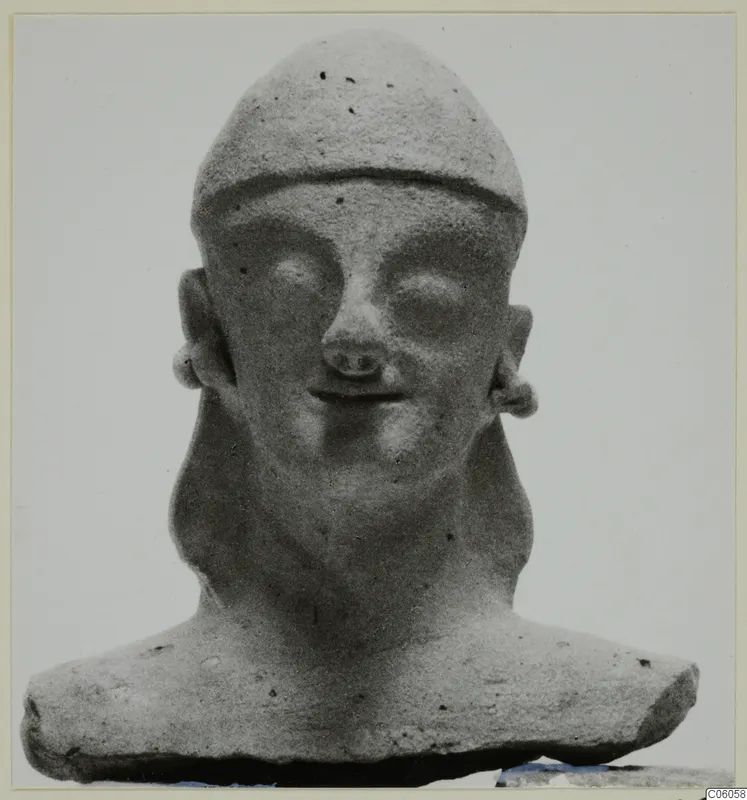 Head and bust of a figure with a close-fitting cap, large eyes and a small smile, shown against a plain background